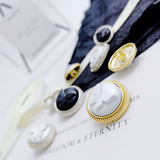 Oil drop butterfly shank buttons