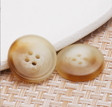 Curved button with thin edge