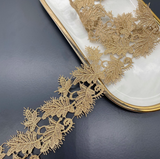 Leaf-patterned Venice lace trim with a scalloped edge.