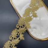 Leaf-patterned Venice lace trim with a scalloped edge.