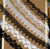 Leaf-patterned Venice lace trim with a scalloped edge.