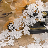 Leaf-patterned Venice lace trim with a scalloped edge.