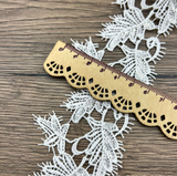 Leaf-patterned Venice lace trim with a scalloped edge.
