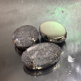 Oval shaped button with mesh over it